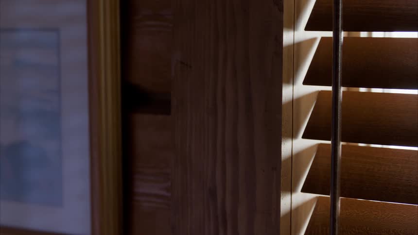 A view of some blinds in front of a window