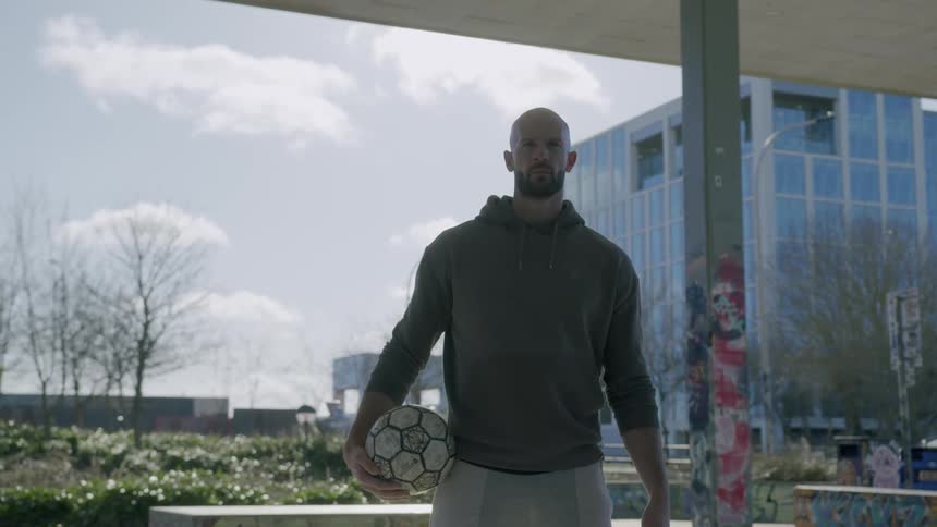 A man holds a soccer ball