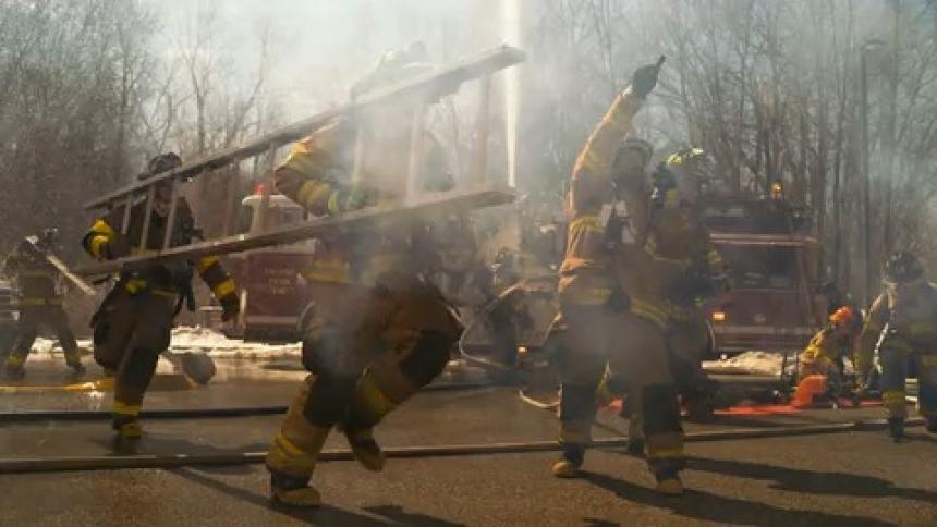 Fireman are spraying water on a fire