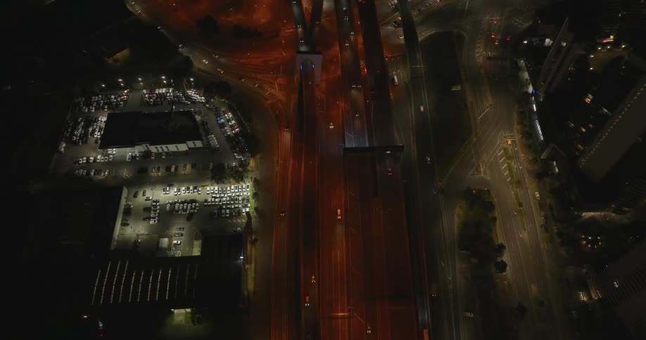 Aerial panorama of a highway and a half to a metropolis at night
