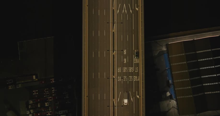 Top view of an overpass at night with vehicle traffic
