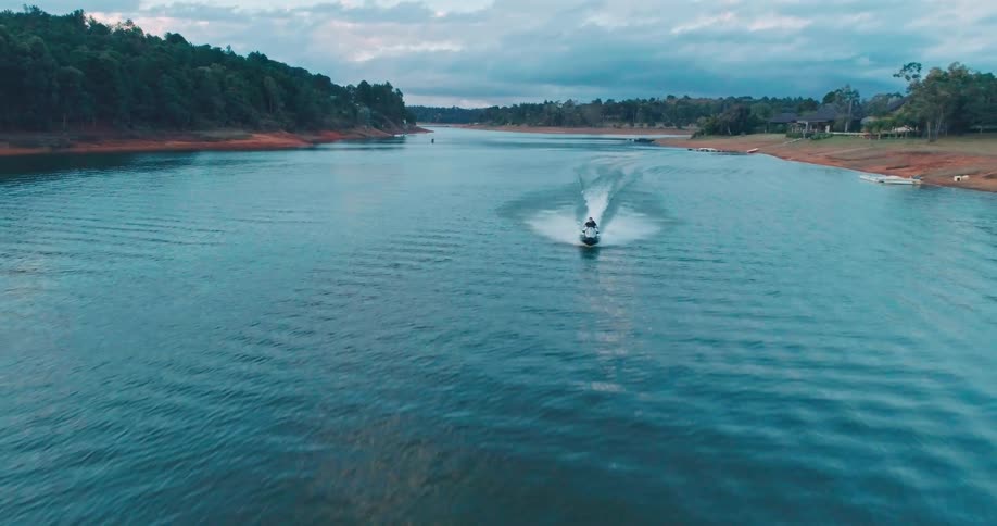 A man riding a jet ski outdoors on a river