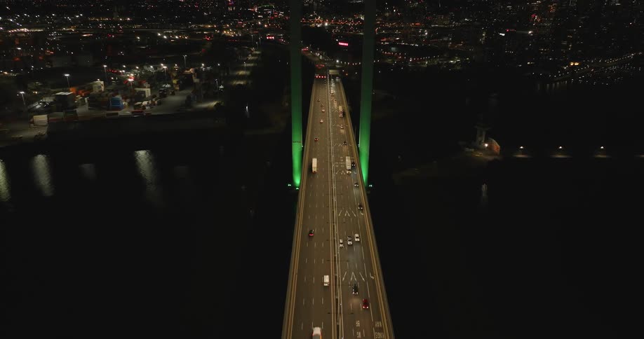 Aerial panorama of a bridge connecting the metropolis with vehicle traffic at night