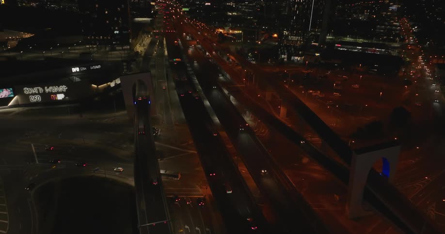 Panorama of a metropolis with highways and overpasses at night with vehicle traffic