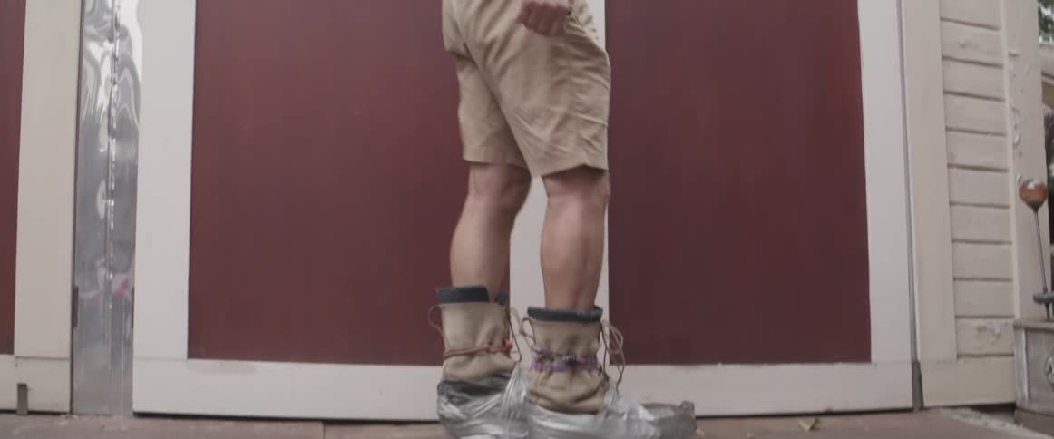 Elderly man with an artificial weight boot walking sideways