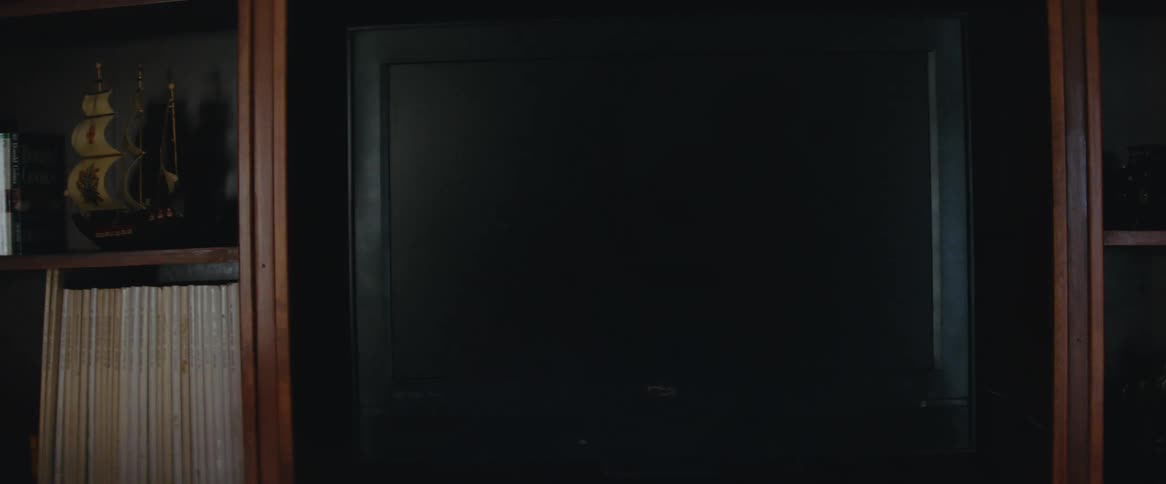 Ablack television turned off on a wooden panel