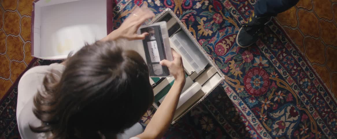 Two people checking a cassette box