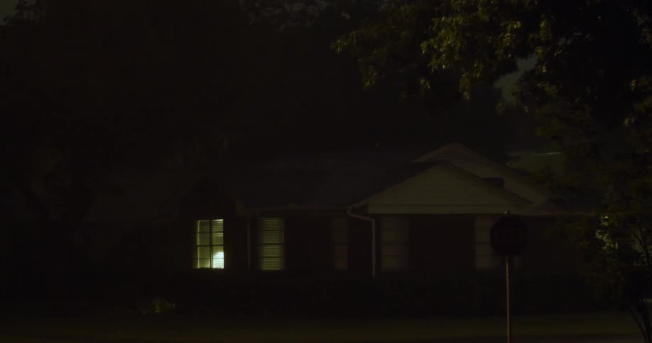 Lighting flashes on a house being filmed from the street