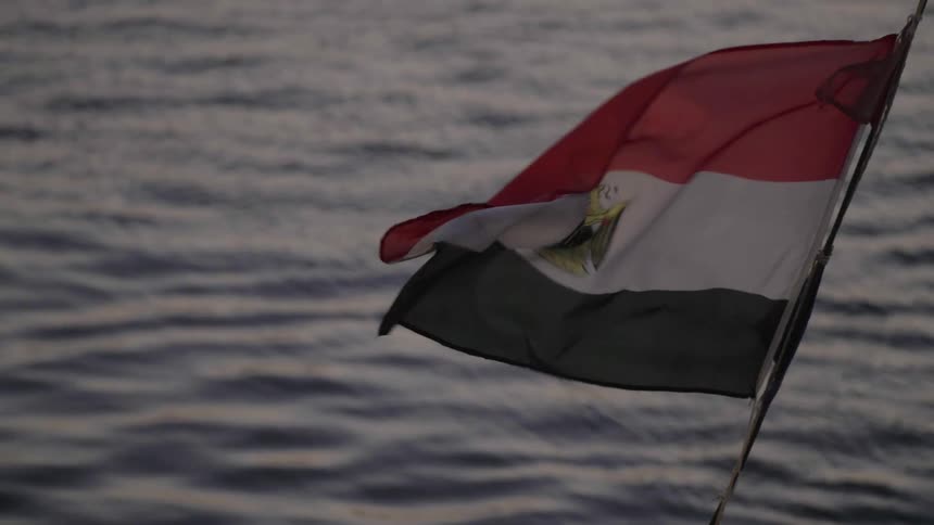 Egyptian flag moving by the force of the wind and in the background of the sea in slow motion