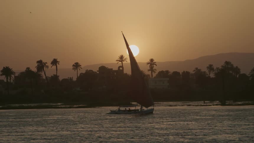 A boat sails past the shore