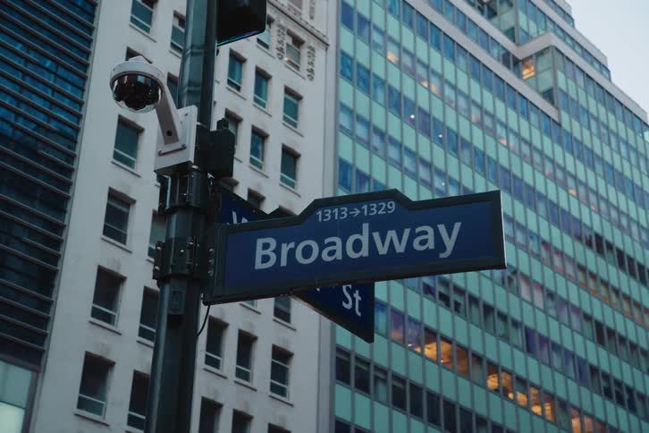 A street sign on a pole in a city