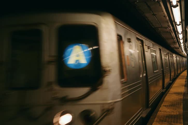 Subway train moving underground at night