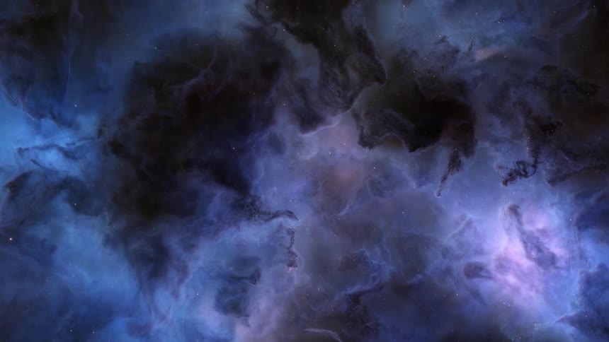 Portion of blue and gray nebula rotating against star filled space shines brightly