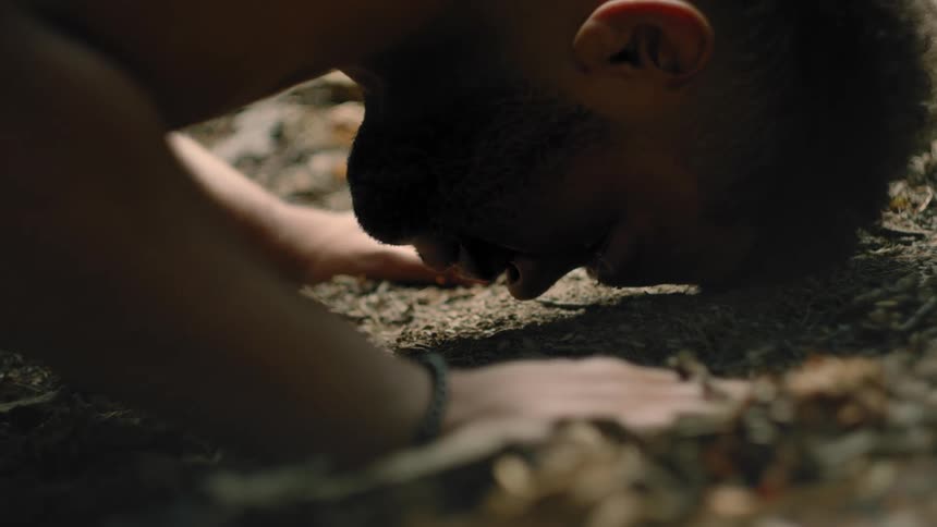 A close up of a man lying face down on the ground