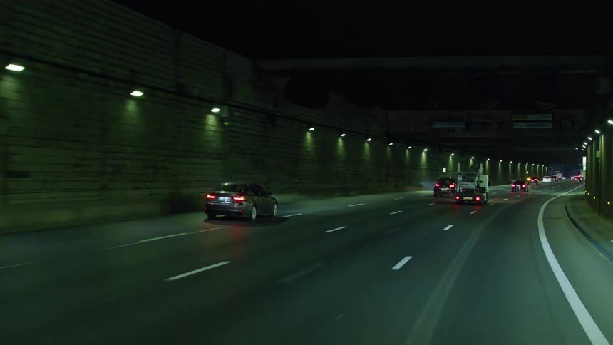 Vehicle traffic inside a tunnel on a viaduct at night