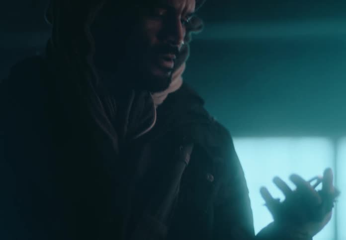A man puts an object in his pocket