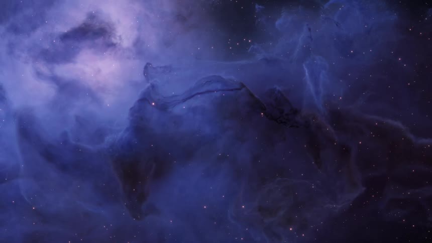 Blue and purple gases of nebula contrast with starry space