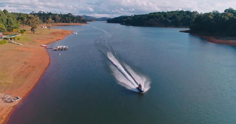 A jet ski runs through the river