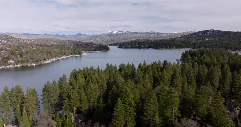 Forests line the shores of a large body of water lined with residences