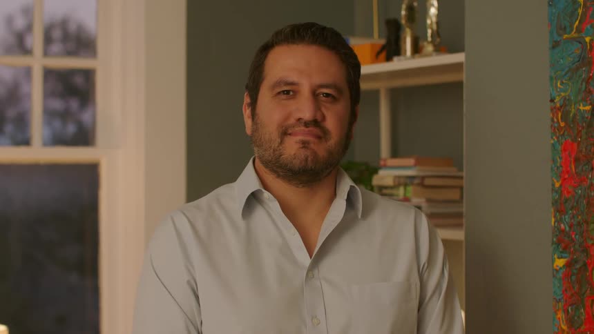 A man standing in a room smiling