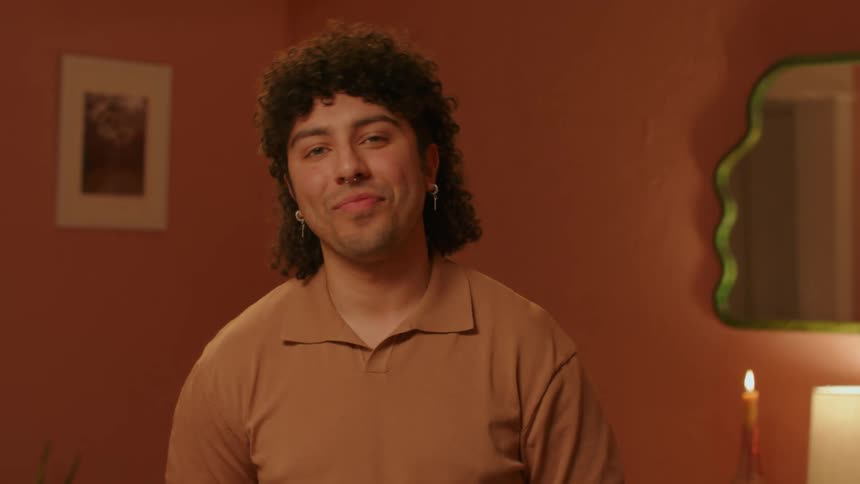 Portrait of a man standing in the room smiling