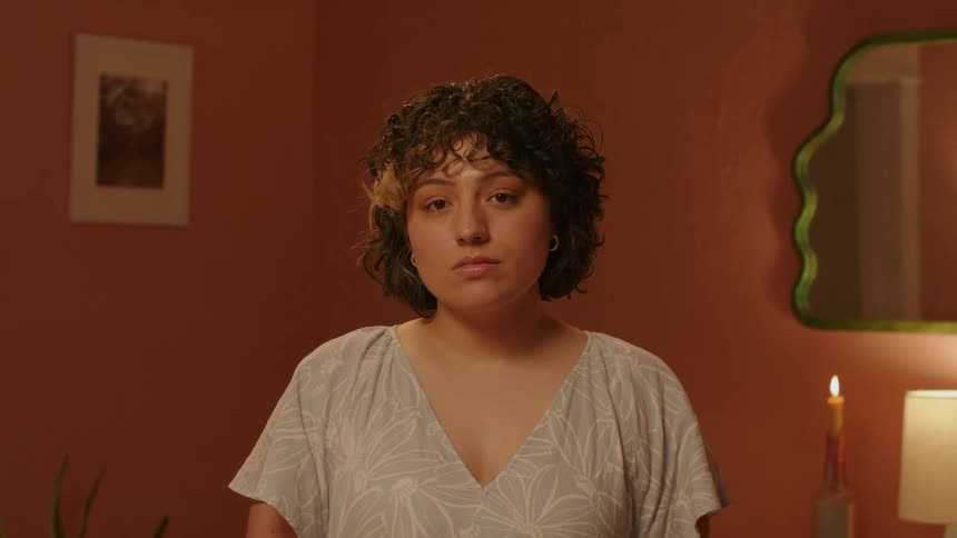 Face of a lady standing alone in a room