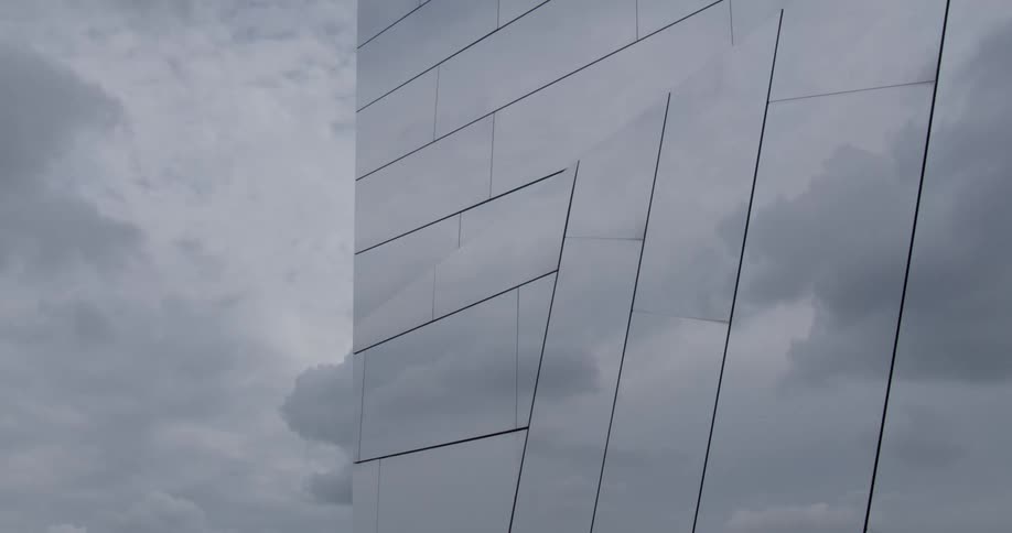 Exterior of a mirrored building on a cloudy day