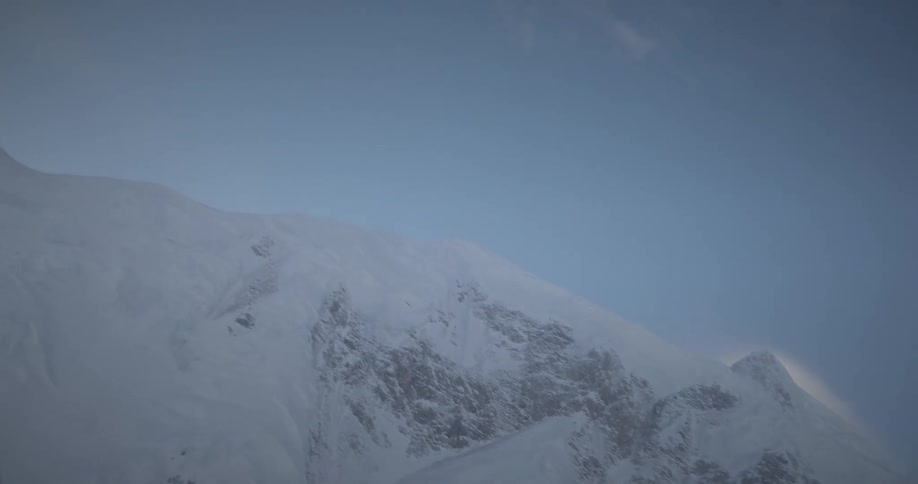 Aerial of a mountain peak with snow during winter