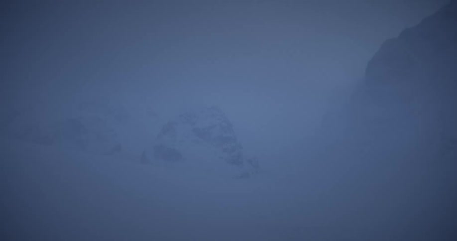 View of snowcovered mountains in a winter snowstorm