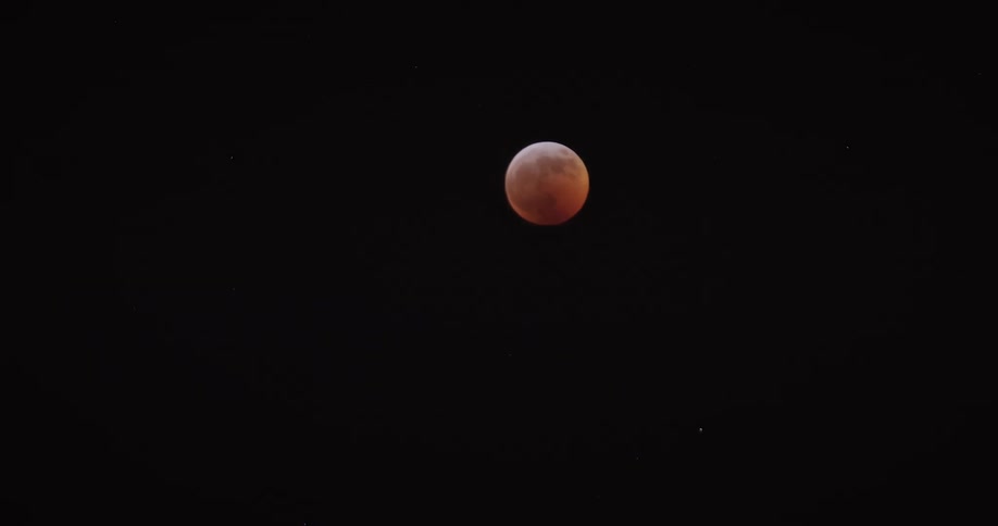 Bright red full moon in the starry sky