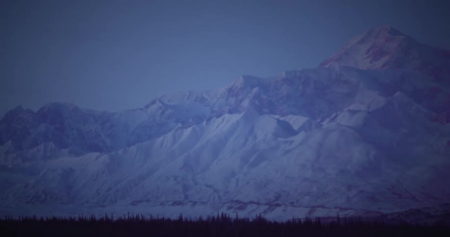 Mountains covered in ice and snow during dusk