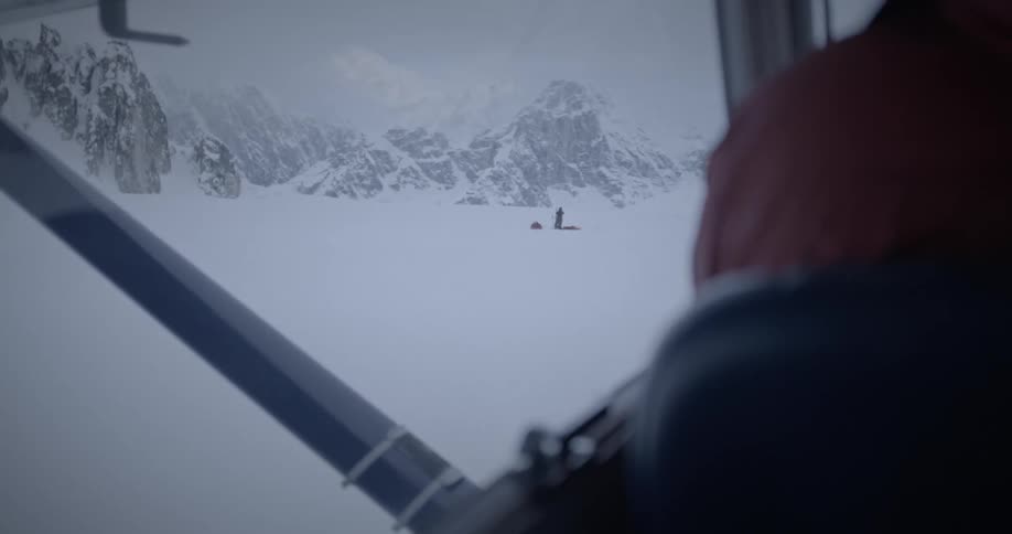 People snowboarding in a mountain area during the day