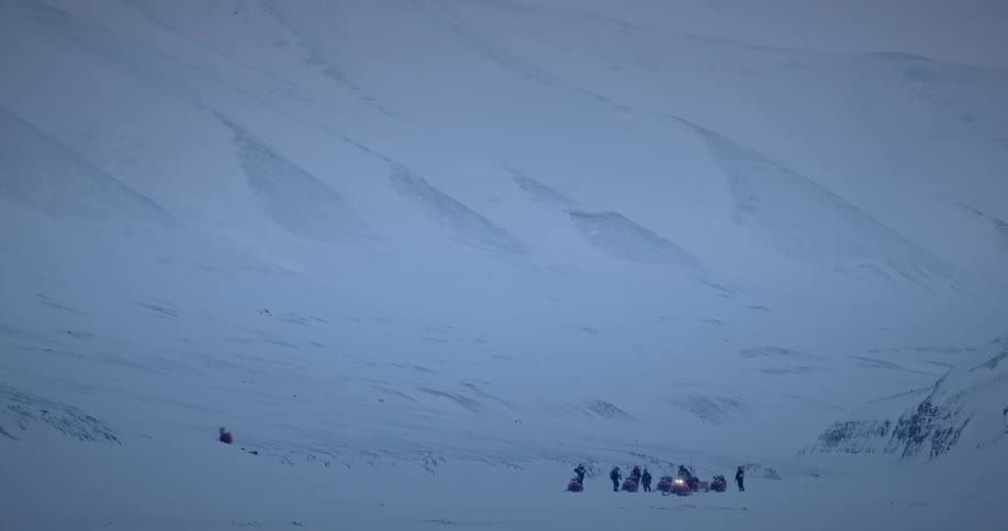 View of a group of people in the midst of snowcovered mountains