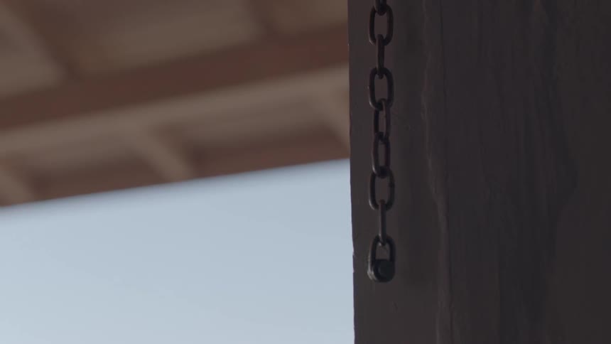 A chain hangs from a wall