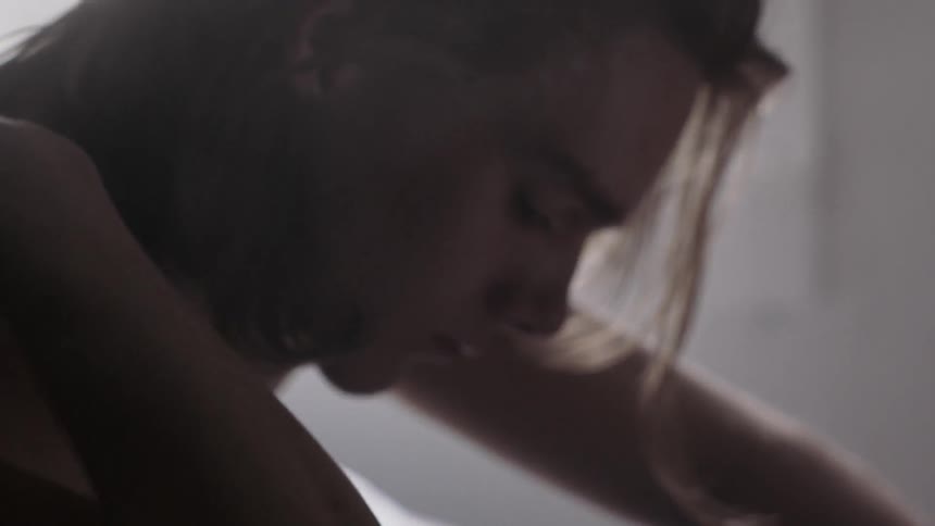 A woman is running her hand through her hair