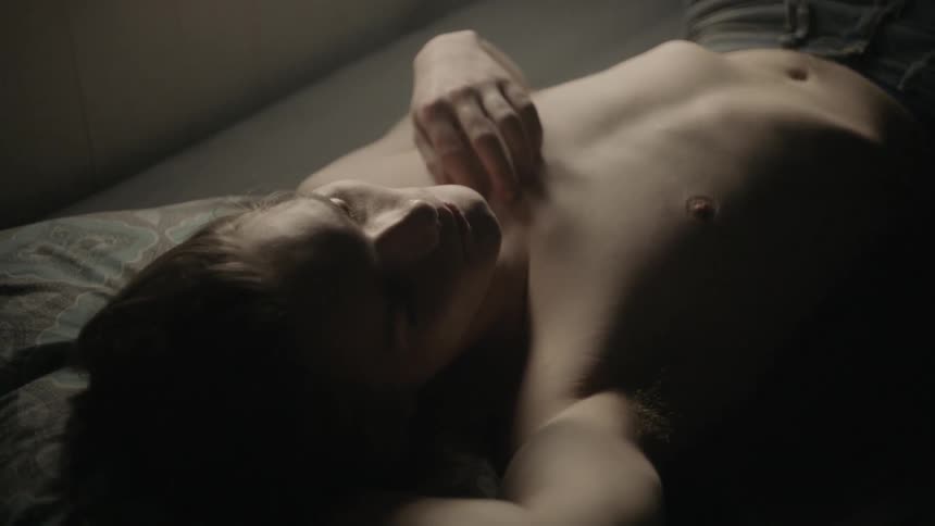 A man laying on a bed sleeping