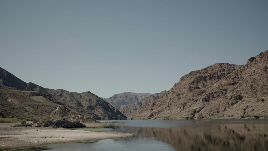 A lake surrounded by hills on a clear day