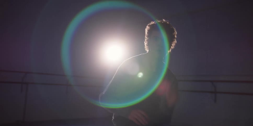 A dancer is performing under a spotlight