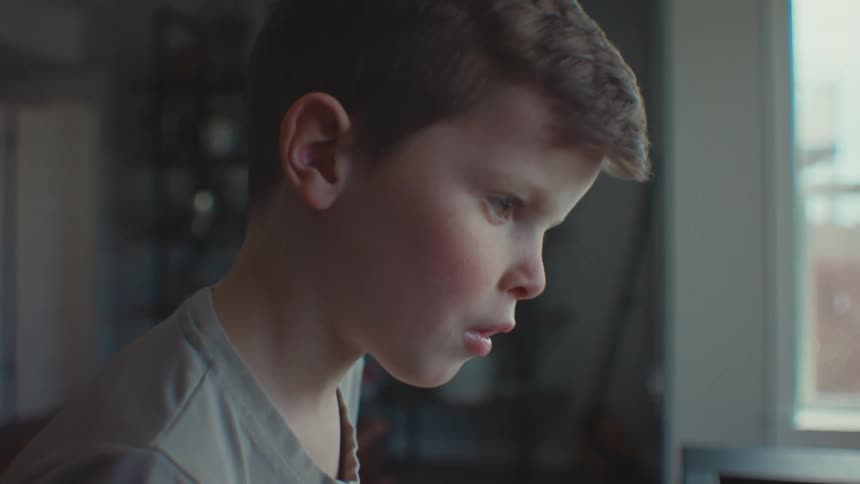 Portrait of a little boy judging while concentrating
