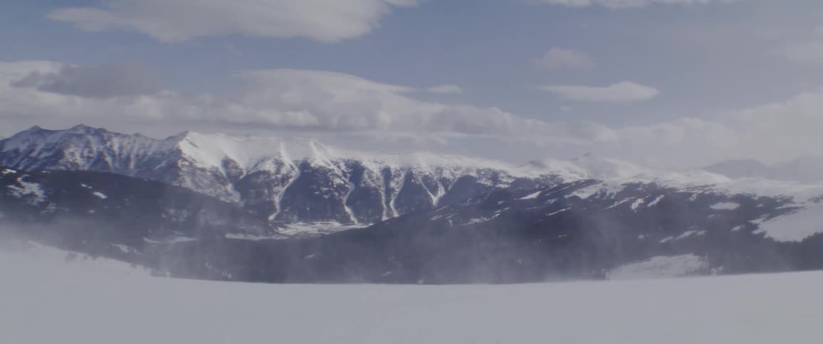 Wind blows snow around in a mountain region