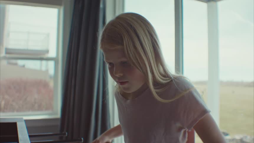 A child is playing foosball at home
