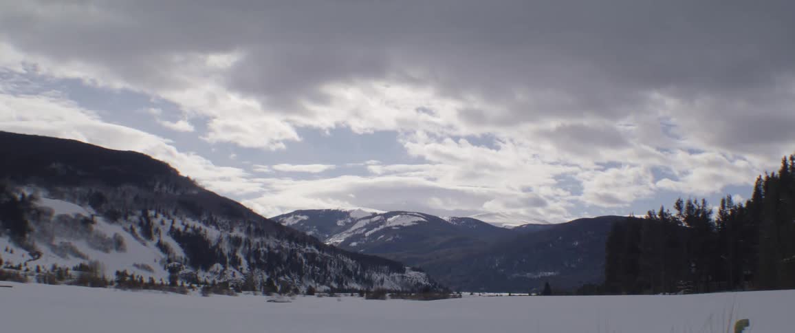 Snow covers mountains and a plain