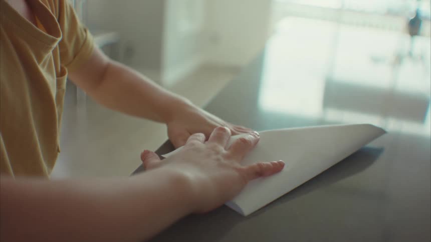 A boy folding a paper plane