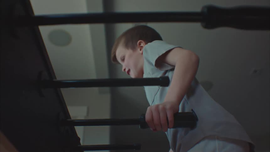 A young boy playing table football