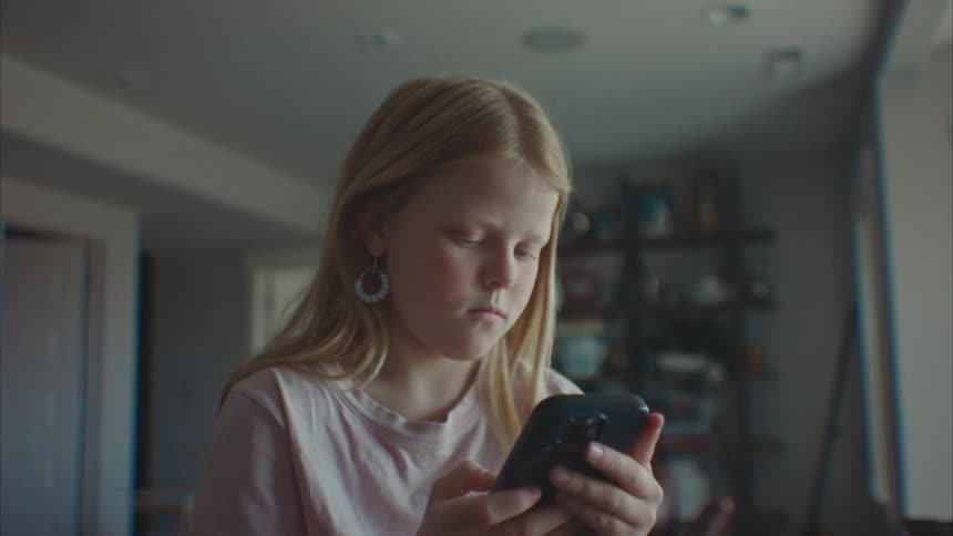 A child is using her cell phone