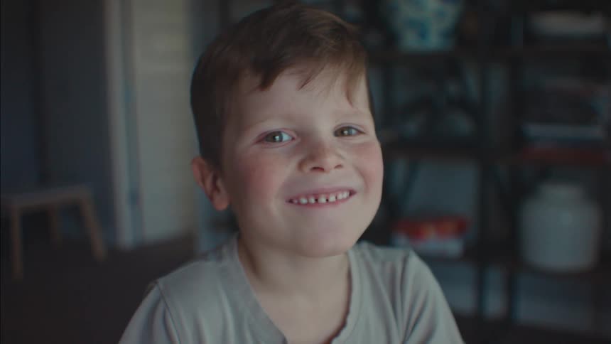 A young boy smiling and laughing