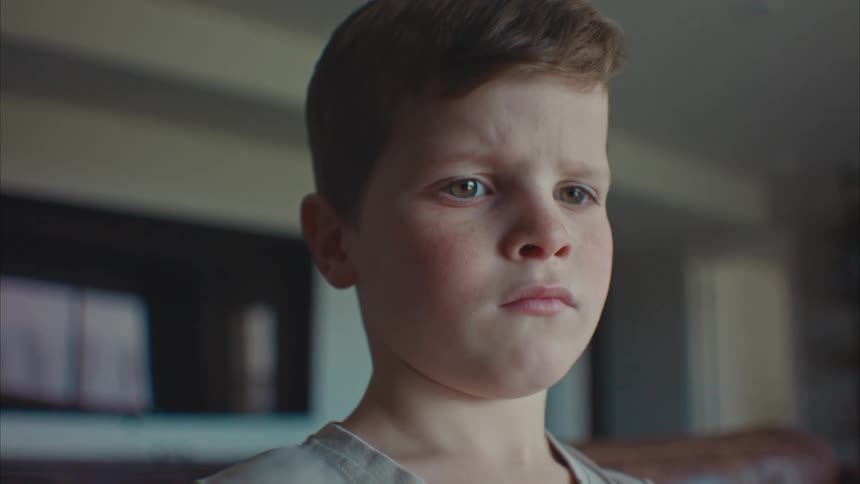 Closeup of a boys face with a thoughtful expression