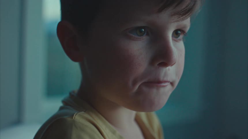 A boy chewing with a determined look