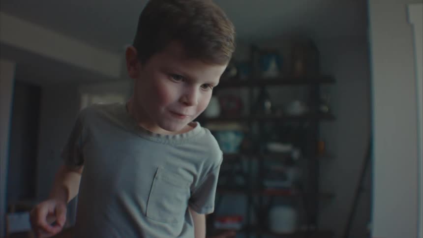 Boy concentrated and having fun while playing in a game room