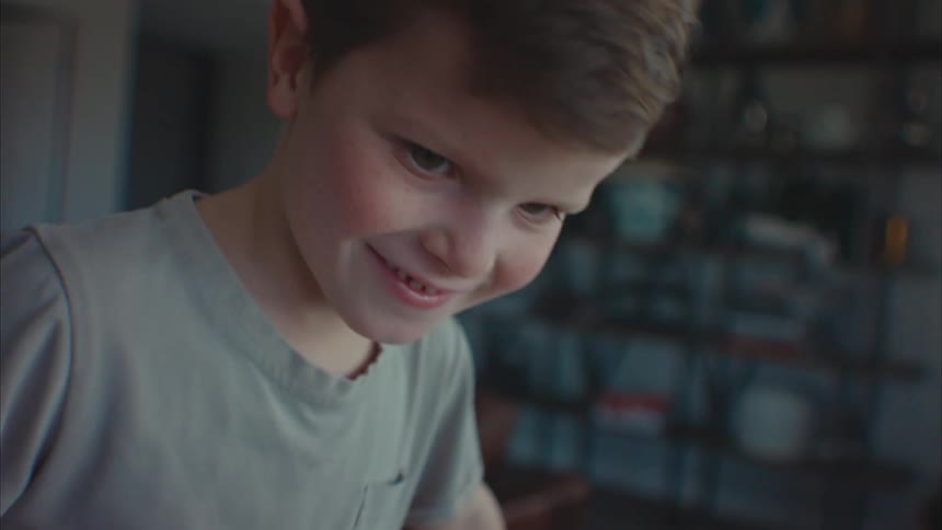 A young boy playing and smiling